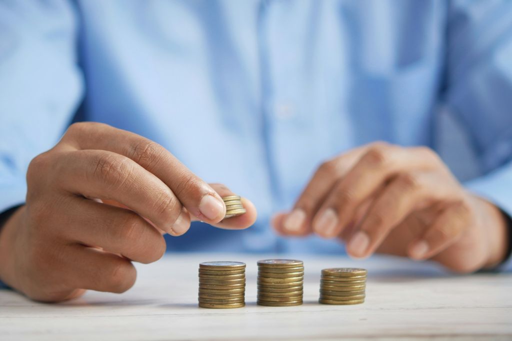Man stacking coins to represent BVI offshore company benefits